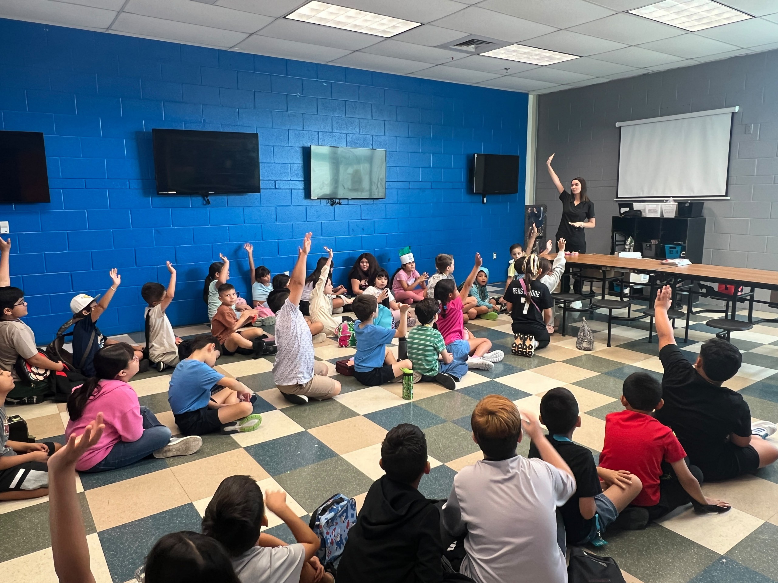 Red Square Dental & Orthodontics team visiting the Boys & Girls Club of McAllen for Career Week to teach kids about dental hygiene.